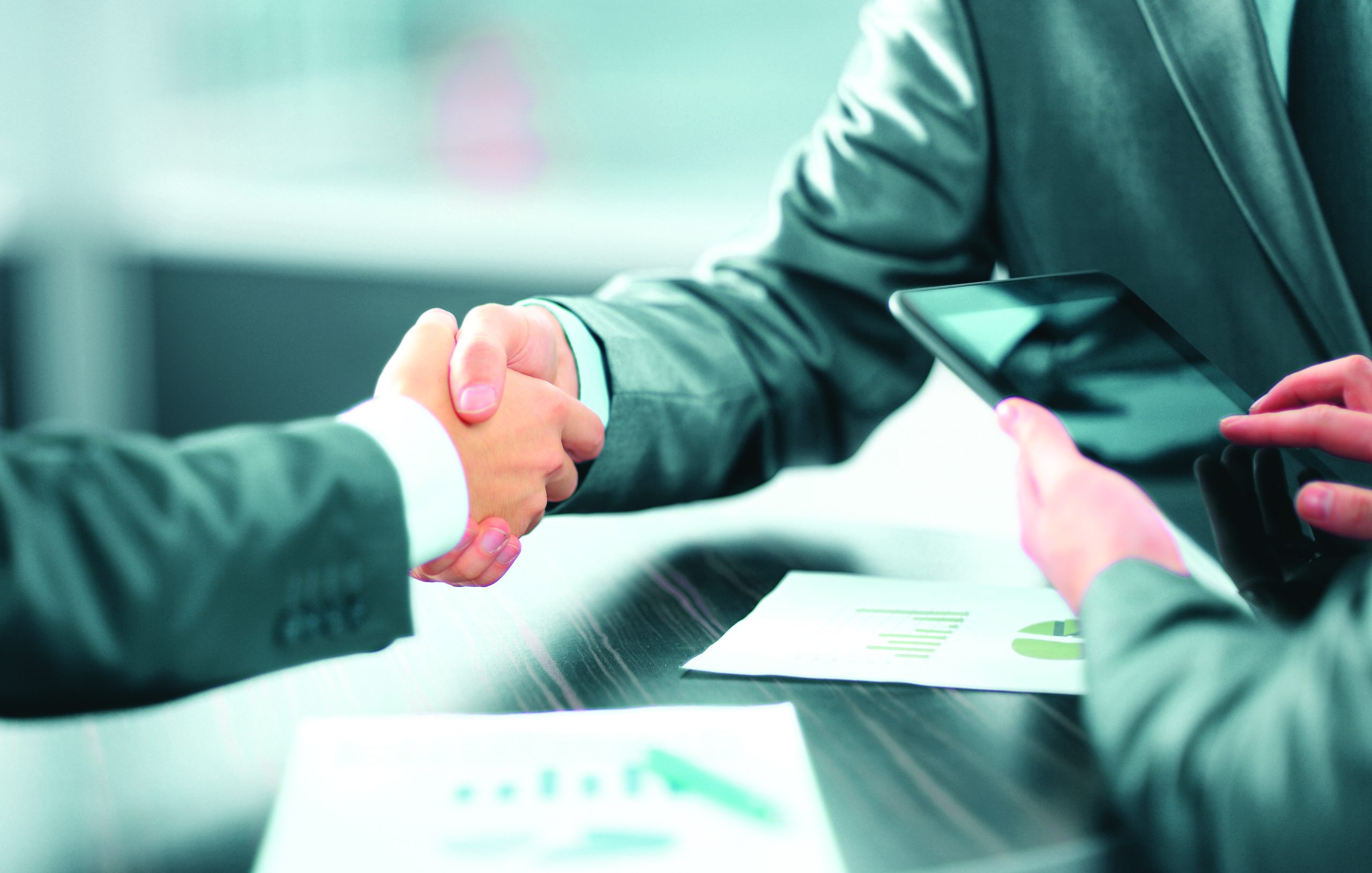business people shaking hands in office